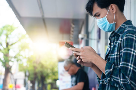 Man wear face mask using mobile smartphone