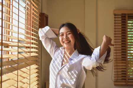 Happy women get up on bedroom morningの写真素材