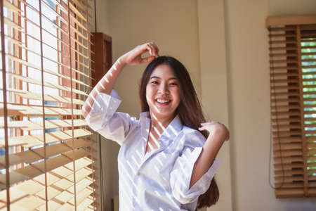 Happy women get up on bedroom morningの写真素材