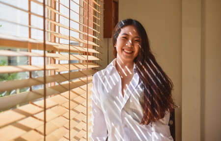 Happy women get up on bedroom morningの写真素材