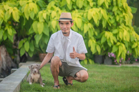 Man and dog puppy happy American bullyの写真素材