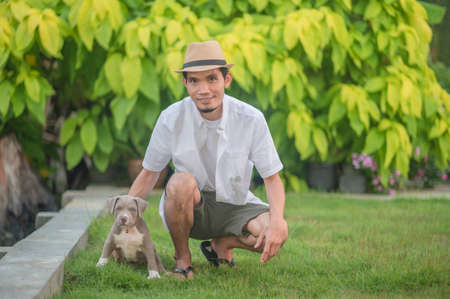 Man and dog puppy happy American bullyの写真素材