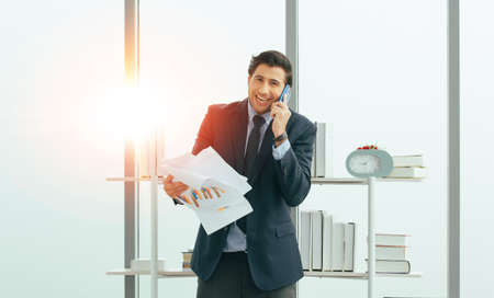 Businessman call phone happy business margin in officeの写真素材