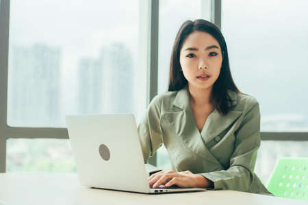 Businesswoman using laptop computer on work spec , Women trader online tradingの写真素材