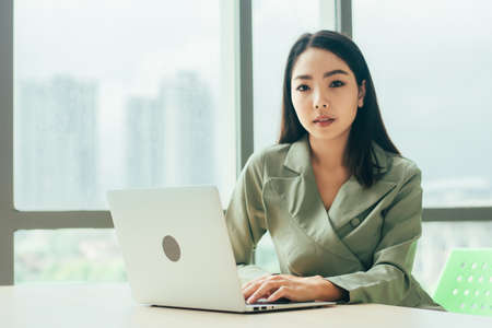 Businesswoman using laptop computer on work spec , Women trader online tradingの写真素材