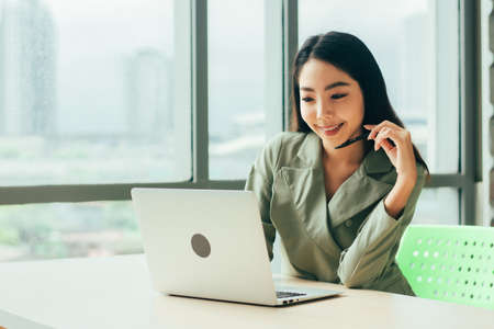 Businesswoman are smile and using computer at window office Trade stock marketの写真素材