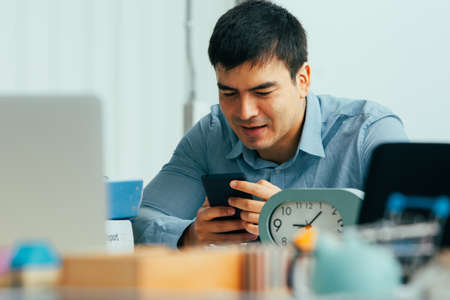 Man trading online on mobile smartphone trade stock marketの写真素材