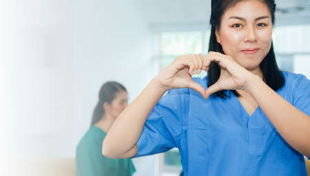 Doctor Women hand shape heart healthy care concept and world heart dat conceptの写真素材