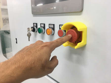 hand touch on Emergency button machine in factory industrialの写真素材