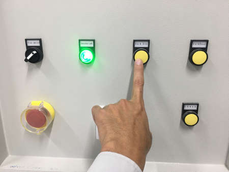 hand touch on button machine in factory industrialの写真素材