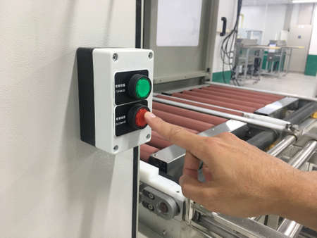 hand touch on button machine in factory industrialの写真素材