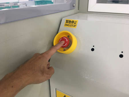 hand touch on Emergency button machine in factory industrialの写真素材