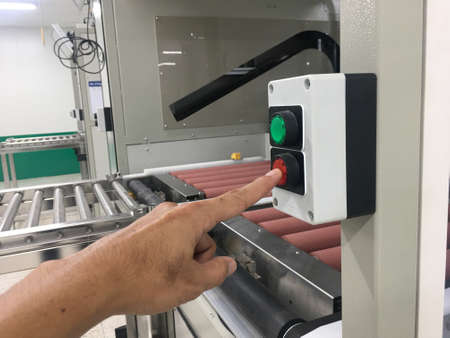 hand touch on button machine in factory industrialの写真素材