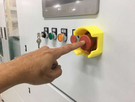 hand touch on Emergency button machine in factory industrialの写真素材