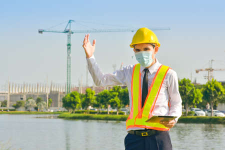 Professional engineer standing outdoors on construction site  working.の写真素材
