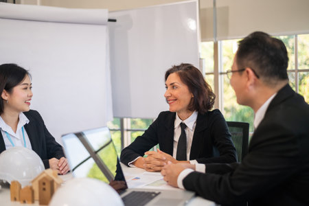 Marketing team meeting to plan business for sale of housing projects and real estateの写真素材