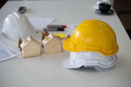 Hard hat helmet on desk engineer home construction projectの写真素材