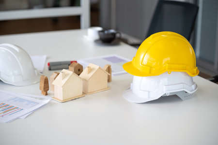 Hard hat helmet on desk engineer home construction projectの写真素材