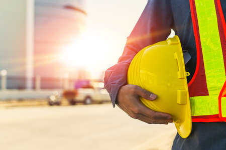 Engineer construction holding hard hat, Technician holding helmet , worker architecture with safety hard hatの写真素材
