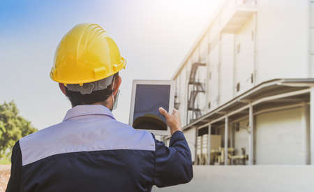 Safety Engineer using tablet inspection efficiency facility manufacturing of factory , Designer architecture engineering, Workplace production controlの写真素材