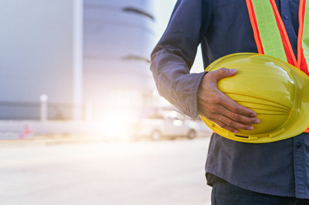Engineer construction holding hard hat, Technician holding helmet , worker architecture with safety hard hatの写真素材