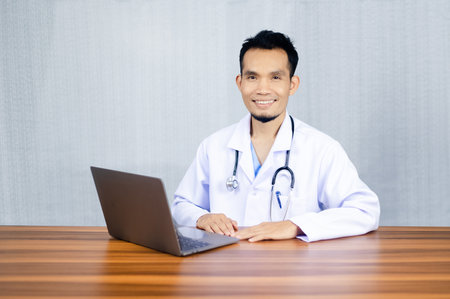 Doctor use computer connection server data base patient for technology treatment in hospitalの写真素材