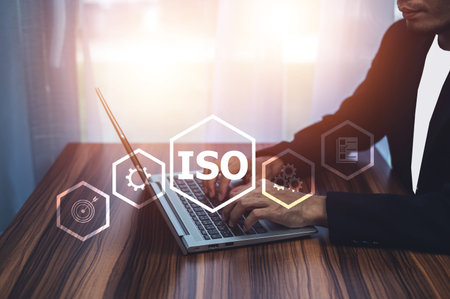 Quality assurance Manager use laptop search ISO standards quality control concept, assurance...