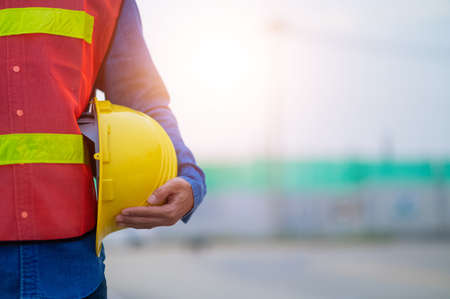Engineer holding hard hat construction worker professional safety work industry building person manager serviceの写真素材