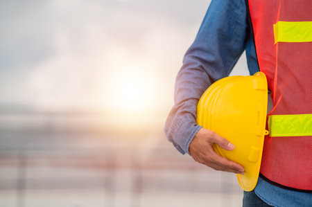 Engineer holding hard hat construction worker professional safety work industry building person manager serviceの写真素材