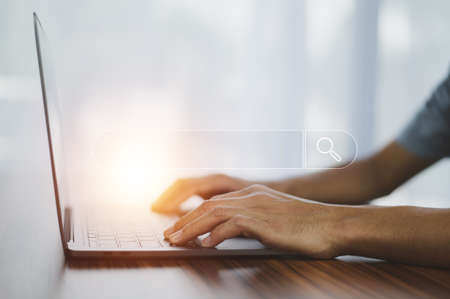 Man using laptop computer search on internet mobileの写真素材