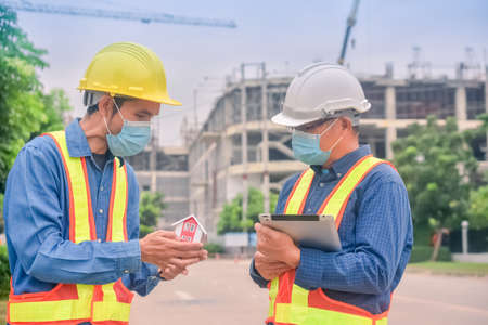 Asian engineer construction team checking work for control and management in the construction site or building siteの写真素材