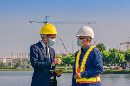 Asian engineer construction team checking work for control and management in the construction site or building siteの写真素材