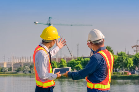 Asian engineer construction team checking work for control and management in the construction site or building siteの写真素材