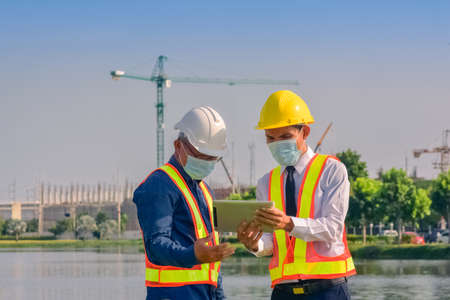 Asian engineer construction team checking work for control and management in the construction site or building siteの写真素材