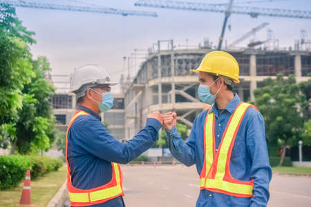 Asian team Construction engineers supervising progress of construction project stand on new factory, Engineering Consulting People on construction site Building inspector.の写真素材