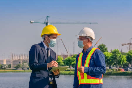 Asian engineer construction team checking work for control and management in the construction site or building siteの写真素材