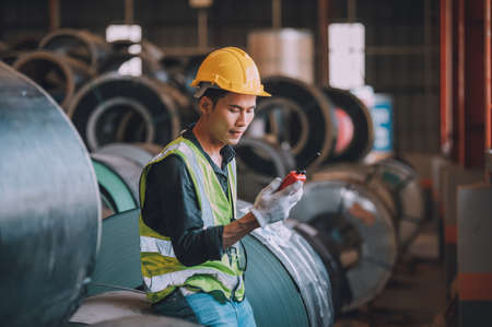 Asian man engineer  working hard in factory , worker employee  hard hat safety control machine factoryの写真素材