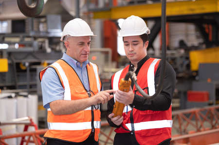 engineer team worker teaching help talking production machine Industry and  work in factory. staff operate control heavy machine in factoryの写真素材