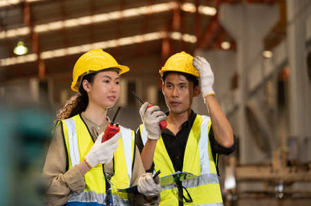 Team Asian engineer working control machine in factory. Group people Asia Worker control machine with manufacturing of industry.の写真素材