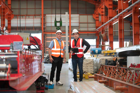 Two people staff audit team checking safety in factory, Engineer talking training coworker team companyの写真素材