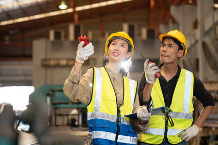 Team Asian engineer working control machine in factory. Group people Asia Worker control machine with manufacturing of industry.の写真素材