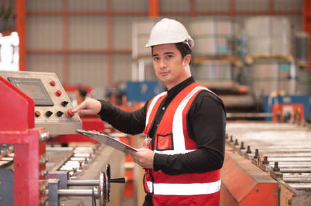Asian man engineer  working hard in factory , worker employee  hard hat safety control machine factoryの写真素材