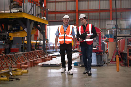 Two people staff audit team checking safety in factory, Engineer talking training coworker team companyの写真素材