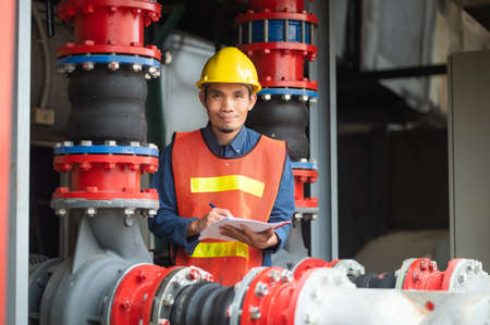 Asian man engineer are working in factory and checking safety system control on production industrialの写真素材