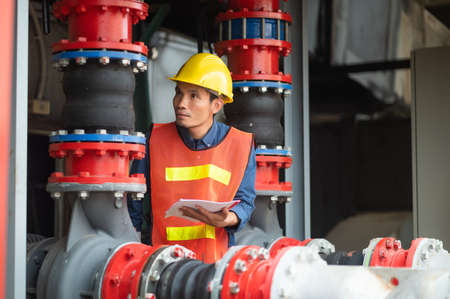 Asian man engineer are working in factory and checking safety system control on production industrialの写真素材