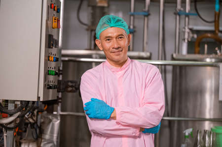 Confident Asian man employee working in food Factory industry , Asia Worker work in food factoryの写真素材