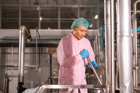 Asian  man employee working in food Factory industryの写真素材