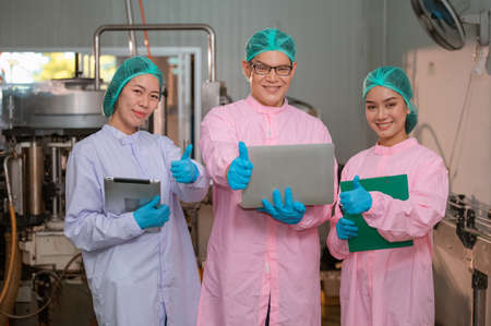 Teamwork Asian manager and employee working Food quality control in Factory and worker in production line beverage factory Concept food factory industryの写真素材