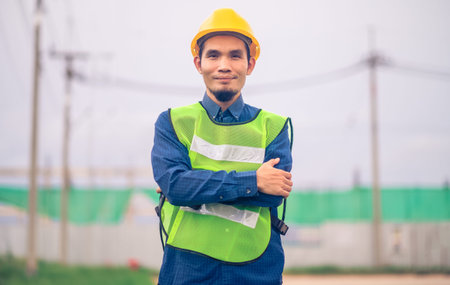 Asian Engineer standing outdoor on site construction posting confident , Engineer construction happy...