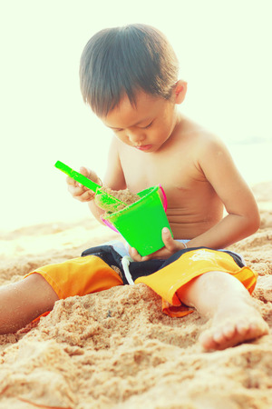 Little boy playing on beachの写真素材